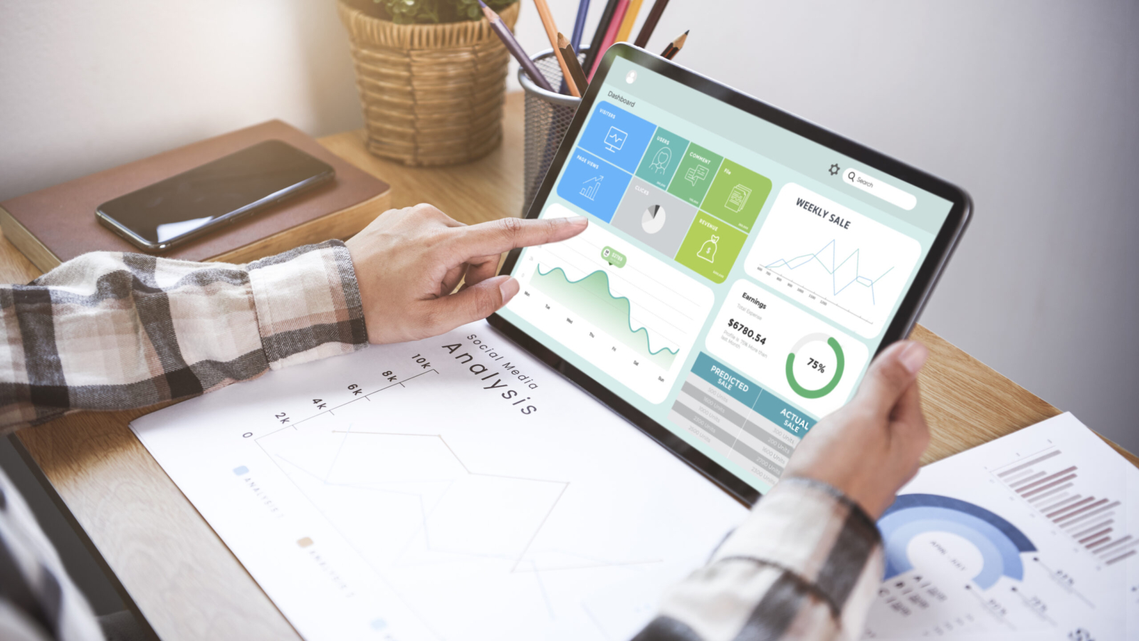 Businesswoman using a tablet to analysis graph company finance strategy statistics success concept and planning for future in office room.
